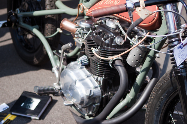 Several Motorräder auf einer Straße mit einem Buch in der Nähe geparkt.