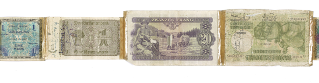 Altes Buch mit verschiedenen Nennwerten von deutschen Banknoten darauf gestapelt.