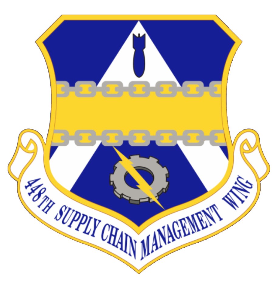 Logo des 48. Versorgungsgeschwader mit einem blauen Schild mit einem weißen Stern und einem weißen Banner mit der Aufschrift "Versorgungsgeschwader" in blau, alles von einem weißen Rand mit schwarzem Text umgeben.