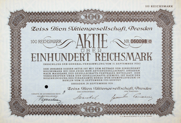 Alter deutscher Aktienzertifikat für 100 Reichmark mit schwarzem Rand und deutschem Text.