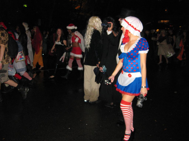 Eine Gruppe von Menschen, einige in Theaterkostümen, die über einen Boden gehen.