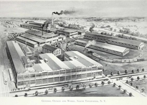 Luftaufnahme eines factories mit Rauch, umgeben von Gebäuden, Bäumen und Fahrzeugen auf der Straße, mit dem Text "General Office and Works, North Tonawanda, New York" unten.