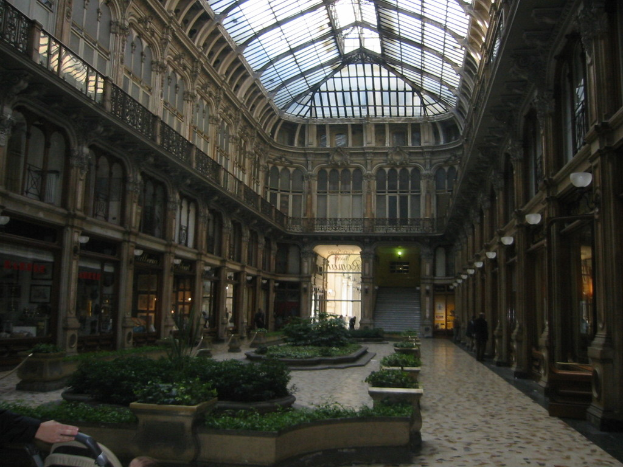 Ein Gebäude mit elektrischen Leuchten, Masten, Namensschildern und Topfpflanzen.